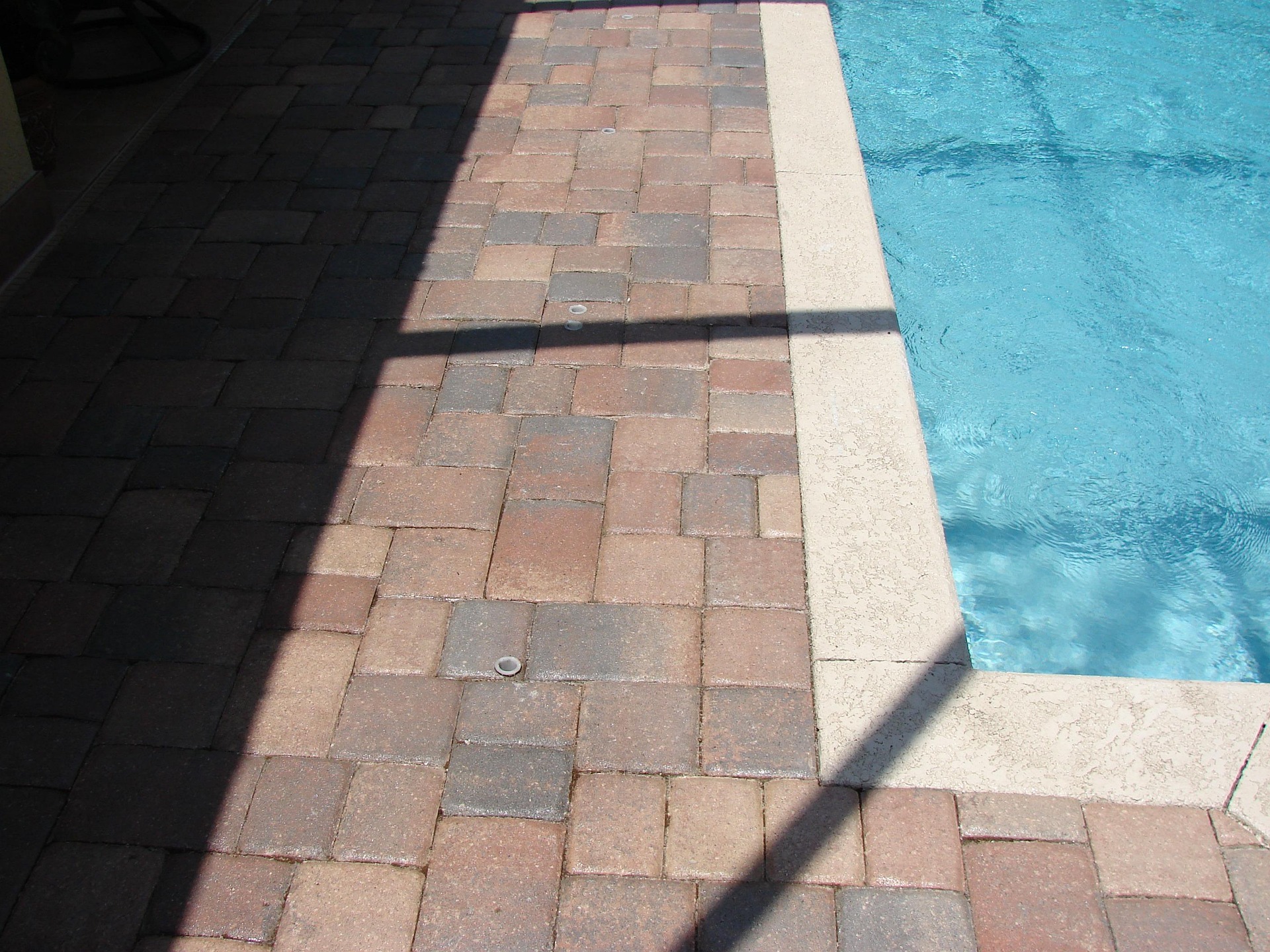 Brick pavers beside a swimming pool